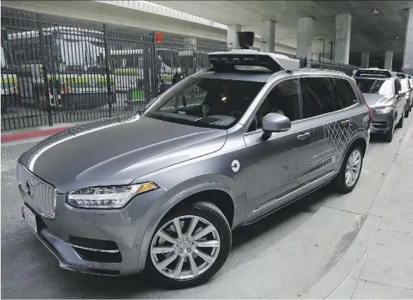  ?? ERIC RISBERG/THE ASSOCIATED PRESS FILES ?? A self-driving Volvo Uber heads out for a test drive in San Francisco last December. Ride-hailing firm Uber Technologi­es and Volvo were among companies that formed partnershi­ps last year to take advantage of the driverless revolution.