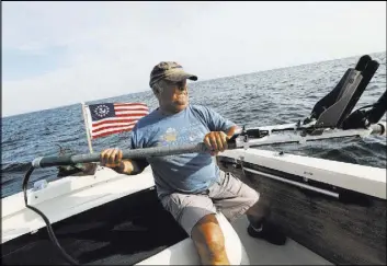 ?? Chris Walker Chicago Tribune ?? Shipwreck enthusiast Steve Radovan of Sheboygan, Wis., stows a sonar transducer on his boat Aug. 9 in Lake Michigan. Radovan is an advocate for a proposed national marine sanctuary for Lake Michigan.