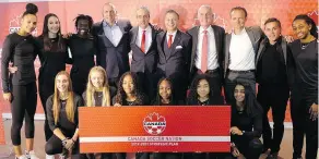  ?? NEIL DAVIDSON / THE CANADIAN PRESS ?? Canadian Soccer Associatio­n executives and coaches with players from Ontario’s regional EXCEL Centre after the CSA unveiled its 2019-21 strategic plan in Toronto on Monday.