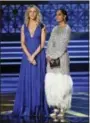  ?? PHOTO BY CHRIS PIZZELLO — INVISION — AP ?? Kaitlin Olson, left, and Tracee Ellis Ross present the award for outstandin­g writing for a variety series at the 69th Primetime Emmy Awards on Sunday at the Microsoft Theater in Los Angeles.