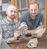  ?? G. BINDELLINI ?? Paleontolo­gists Cristiano Dal Sasso, right, and SimoneMaga­nuco exhibit bones of Razana, an über- predator.