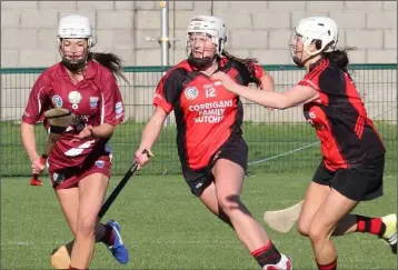  ??  ?? Katie O’Connor, the St. Martin’s captain, breaking away from Siobhán Sinnott and Mary Leacy.