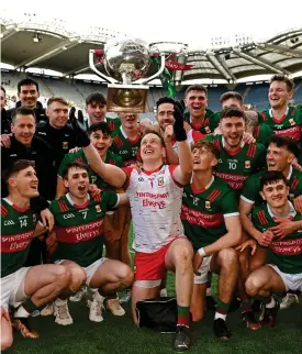  ?? ?? Victory: Mayo’s Colm Reape throws the cup in the air last year