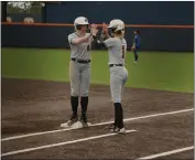  ?? PHOTO COURTESY OF MEGAN VALENTE — COLLEGE OF THE REDWOODS ?? The Corsairs’ Allie Egbert (left) and Sadie Hampton (right) high five during an early season game. Redwoods swept their doublehead­er against Yuba on Wednesday.