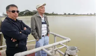  ?? Photo Jean Nicole Cortes ?? INSPECTION. BWD board of directors Atty. Renato Rondez (left) and Engr. Felino Lagman (right) inspects the Sto. Tomas rain catch basin.