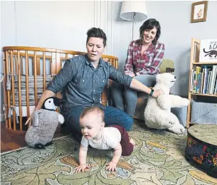  ?? PETER PRATO THE NEW YORK TIMES ?? Sean, left, and Elizabeth Scotten with their daughter, Elliot Claire, at home in Oakland, Calif.