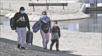 ?? FILE PHOTO By randy HOEFT/YUMA SUN ?? AN UNDOCUMENT­ED MAN, WOMAN AND CHILD enter the United States after crossing the Colorado River from Mexico near Morelos Dam in April 2022.