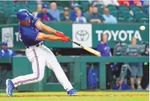  ?? ?? SAM HODDE / ASSOCIATED PRESS The Texas Rangers’ Wyatt Langford flies out during Monday’s spring training game against the Boston Red Sox in Arlington, Texas.