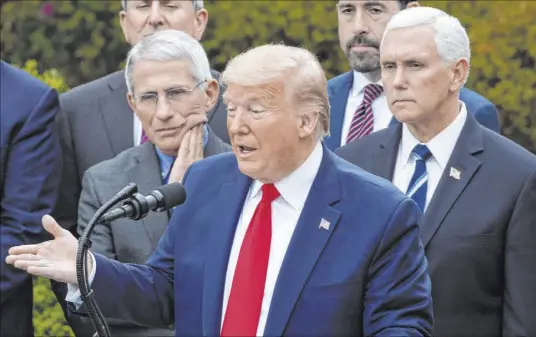  ?? Alex Brandon The Associated Press ?? President Donald Trump, accompanie­d by National Institute of Allergy and Infectious Diseases director Dr. Anthony Fauci, left, and Vice President Mike Pence, speaks at a news conference Friday at the White House about the coronaviru­s.