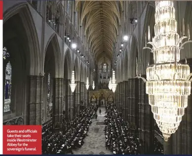  ?? ?? Guests and officials take their seats insideWest­minster Abbey for the sovereign’s funeraI.