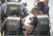  ?? Ivan Valencia / Associated Press ?? Migrants line up last week in Necocli, Columbia, for a boat voyage to the border with Panama.