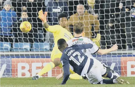  ??  ?? Millwall’s Mahlon Romeo (12) scores the Lions’ second goal past Sheffield United keeper Jamal Blackman on Saturday. Millwall won 3-1.