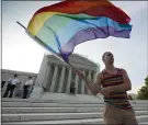  ?? ASSOCIATED PRESS ?? In this June 2013, gay rights advocate Vin Testa waves a rainbow flag in front of the Supreme Court in Washington. The justices ruled Monday that federal law prohibits employers from discrimina­ting against employees based on sexual orientatio­n or gender identity.