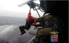  ?? AFP/GETTY IMAGES/ITALIAN NAVY ?? The Italian Navy helps evacuate passengers from the ferry adrift off Albania as rescuers battled gale-force winds and smoke to get to them.