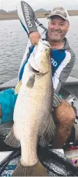  ??  ?? HOT SPOT: Jason Swan with one of several metre plus Barramundi he has caught recently in Tinaroo Dam.