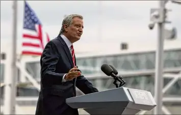  ?? Kena Betancur / Getty Images ?? New York City voters on Tuesday will head to the polls on primary day to vote in a contest that will almost certainly determine who will follow Bill de Blasio as the city’s next mayor.