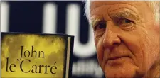  ?? ALASTAIR GRANT — THE ASSOCIATED PRESS FILE ?? British author John le Carre holds a copy of his new book entitled ‘Our Kind of Traitor’ at a central London bookstore during a book signing event to mark the launch of the novel in London Thursday, Sept. 16, 2010.