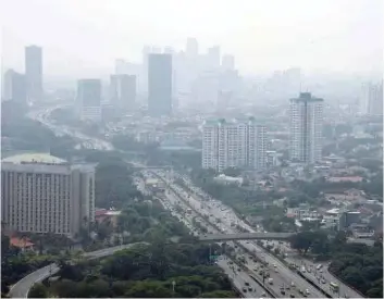  ?? — Reuters ?? A general view of buildings as smog covers the capital city of Jakarta on July 29, 2019 in this photo taken by Antara Foto.