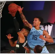  ?? (AP/Kim Klement) ?? Brandon Clarke (15) of the Memphis Grizzlies blocks a shot by Milwaukee Bucks guard Frank Mason III during Thursday’s game at Lake Buena Vista, Fla.