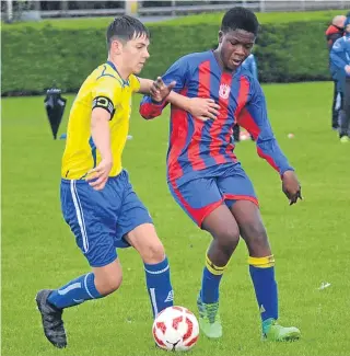  ??  ?? Dundee West U/15s (red and blue) won their Scottish Cup first-round tie against Blue Brazil 2-1.