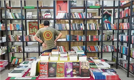  ??  ?? A customer browsing for new arrivals at the Gerakbuday­a bookshop in Petaling Jaya. - DARYL GOH/THE Star