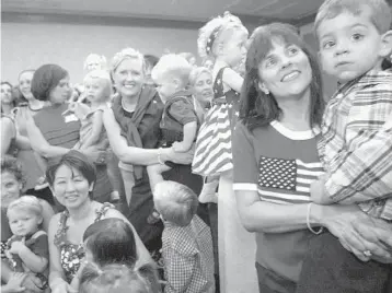  ?? DIANE BONDAREFF/AP ?? Christina Pisera Naman, second from right, and her son, Trevor, of Monroevill­e, Pennsylvan­ia, pose for a photograph with mothers whose children were born on Sept. 11, 2001, during an early birthday celebratio­n in New York on Aug. 10, 2003.