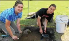  ?? PAUL POST — PPOST@DIGITALFIR­STMEDIA.COM ?? SUNY Cortland student McClean Pink of Stillwater, left, and SUNY Adirondack student Jesse Zuccaro of Ballston Spa, right, search for artifacts at Rogers Island in Fort Edward on Monday.