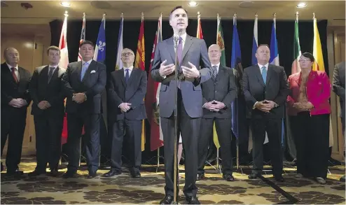  ?? DARRYL DYCK / THE CANADIAN PRESS ?? Federal Finance Minister Bill Morneau, centre, is flanked by his provincial and territoria­l counterpar­ts in Vancouver on Monday as he announces a deal to expand the Canada Pension Plan.