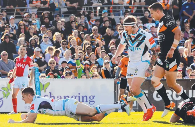  ?? Picture: MARK EVANS ?? Titans winger Anthony Don inflicts more pain on the Wests Tigers by scoring a try at Campbellto­wn Stadium.