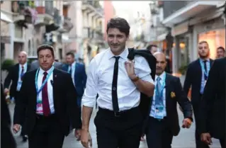  ?? SEAN KILPATRICK, THE CANADIAN PRESS ?? Prime Minister Justin Trudeau walks through the town of Taormina, Italy, Friday as he attends the G7 summit.