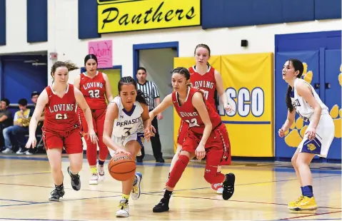  ?? COURTESY JOHN DENNE ?? Peñasco senior wing Jennifer Aguilar controls a loose ball past Loving’s Taryn Chacon in the second half of the Lady Panthers’ 64-49 win in the opening round of the Class 2A State Tournament in Peñasco Jicarilla Gymnasium. Aguilar returned from injuries sustained from a collision with an Escalante player during a Jan. 30 game.