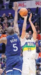  ?? SCOTT THRELKELD/ASSOCIATED PRESS ?? New Orleans forward Anthony Davis (23) shoots over Minnesota center Gorgui Dieng (5) Friday, but he didn’t play in the fourth quarter of a 122-117 Pelicans win.