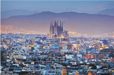  ??  ?? A night-time view over Sagrada Familia and the roof tops of Barcelona. The Spanish city came seventh on the list.