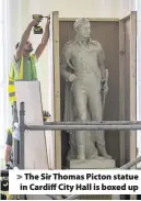  ??  ?? > The Sir Thomas Picton statue in Cardiff City Hall is boxed up