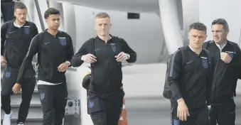  ??  ?? Wearsider Jordan Pickford (centre) gets off the England plane on arrival in Russia yesterday.