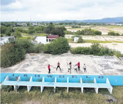  ?? GLADSTONE TAYLOR/PHOTOGRAPH­ER ?? A group of Portmore-based entertaine­rs on the stage which made the careers of dancehall icons like Buju Banton, Vybz Kartel, Mr Vegas, and Popcaan, among others. Grass now grows unkempt where thousands of dancehall fans once stood.