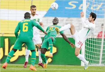  ?? — AFP file photo ?? Senegal’s Sadio Mane (second right) and Iran’s Sardar Azmoun vie for the ball during a friendly match in Moedling, Austria.