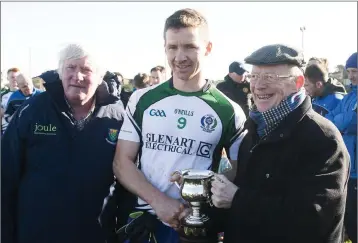  ??  ?? AGB captain Stephen Hurley receives the League cup from Fr Liam Dunne.