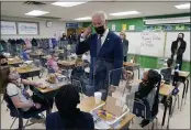  ?? EVAN VUCCI — THE ASSOCIATED PRESS ?? President Joe Biden gestures as he talks to students during a visit to Yorktown Elementary School in Yorktown, Va., as first lady Jill Biden watches on Monday.