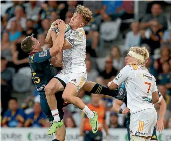  ?? PHOTO: GETTY IMAGES ?? Ben Smith (left) and Damian McKenzie (Chiefs) clash in the air, which led to Smith leaving the field with a head knock, during last night’s Super Rugby match in Dunedin.