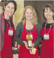  ??  ?? Mountain of Wine volunteers Christa Nicholson, left, Sue Stangl and Sue Finley helped to make the Avalanche Canada. benefit a big success