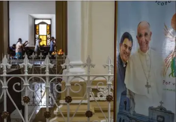  ?? INTI OCON — THE ASSOCIATED PRESS FILE ?? A poster featuring Bishop Rolando Alvarez and Pope Francis hangs inside the Cathedral in Matagalpa, Nicaragua, on Aug. 19.