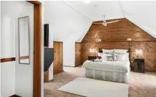  ??  ?? The attic bedroom features a bathroom, built-ins and views over Toowoomba.