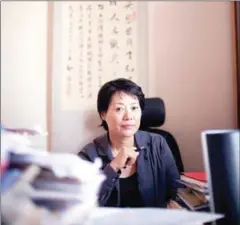  ?? SIM CHI YIN/THE NEW YORK TIMES ?? Guo Jianmei, a lawyer and women’s rights advocate, at her desk in Beijing on August 16, 2011. Guo and a group of fellow lawyers and feminists are urging the Communist Party to promote more women to leadership positions at its congress this fall, but...