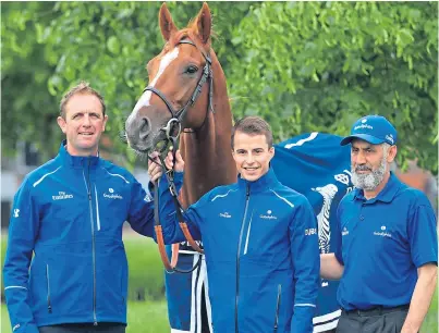  ?? Picture: PA. ?? Trainer Charlie Appleby, left, jockey William Buick and groom Said Bahadar pose with Masar during the Derby winner’s homecoming event at Moulton Paddocks yesterday.