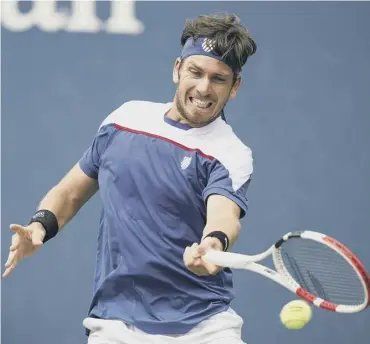  ??  ?? 0 Cameron Norrie plays a return to Diego Schwartzma­n in his stunning five-set win over the No 9 seed.