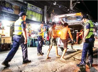  ?? (Jun Ryan Aranas) ?? SATURATION DRIVE – At least 20 persons idly standing in the streets are herded off to the Pasay Police for loitering and violating city ordinances, early Tuesday.