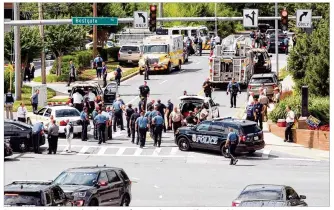  ?? JOSHUA MCKERROW / CAPITAL GAZETTE / TNS ?? First responders descend on the scene of a mass shooting at The Capital Gazette newsroom in Annapolis, Md., on Thursday. A single suspect was taken into custody.