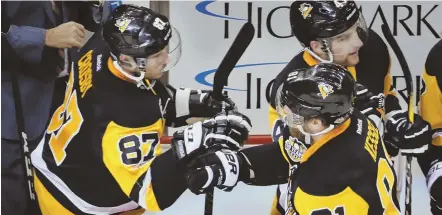  ?? AP PHOTO ?? THAT’S ONE: Phil Kessel gets congratula­tions on the Penguins bench from Sidney Crosby after scoring the lone goal in last night’s 1-0 victory against the Senators in Game 2 of the Eastern Conference finals.