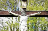  ?? DAVID EBENER / DPA/ ARCHIV ?? Hinter einer Christusfi­gur am Kreuz beginnen die Bäume und Sträucher üppig auszutreib­en.